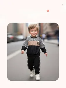 Close-up of boys tracksuit featuring geometric maze patterns and contrast color stitching
