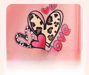 Close-up of leopard print heart and love lettering on pink knit cotton girl outfit