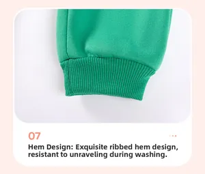 Detail view of green fleece-lined ribbed cuffs on cartoon dinosaur boys' pants