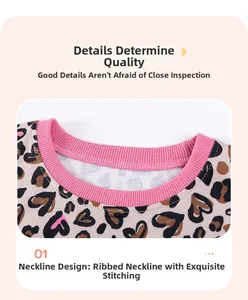 Close-up of leopard print fabric with pink ribbed neckline and reinforced stitching