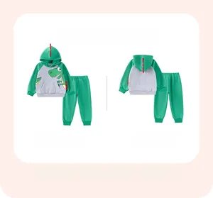 Flat lay of boy's green dinosaur hoodie and joggers set with 3D red dorsal fins