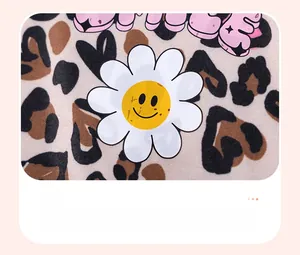 Detail of baby cotton knit fabric with leopard heart print and daisy heat transfer design