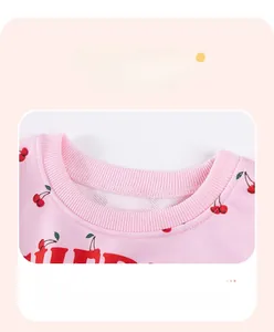 Detail of pink cotton sweatshirt with cherry prints and high-quality ribbed neckline