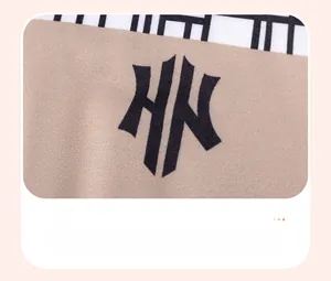 Detail of premium heat transfer print on brown knitted fabric for toddler clothing set