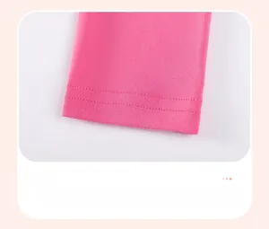 Detail of rose red knitted pants cuff featuring clean double-needle stitching and texture