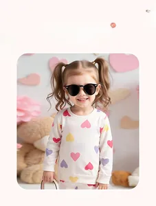 Detail showing girls long sleeve white sweatshirt with colorful heart prints and ribbed cuffs