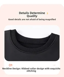 Detail view of black long-sleeve top ribbed neckline with reinforced stitching craftsmanship