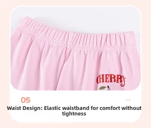 Detail of pink knitted cherry pants featuring elastic waistband for comfortable fit