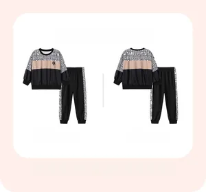 Front and back view of boys' two-piece sport set with geometric patchwork and HK lettering