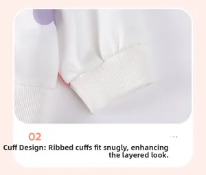 Detail of ribbed cuffs on girls' white sweatshirt featuring pink cloud patterns