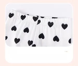 Detail view of elastic waistband on white girls' set with black heart print pattern