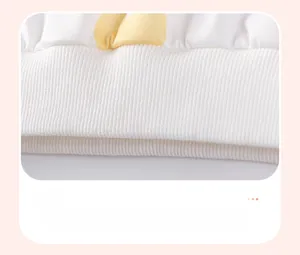 Macro view of elastic ribbed hem on white cotton girl's sweatshirt for shape retention