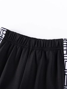 Boys black sports shorts with elastic waistband and Greek key pattern side stripes
