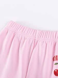 Pink elastic waist girls trousers featuring cute red cherry print and soft knit fabric