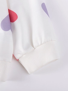Girl's white long sleeve sweatshirt with red and purple heart patterns and ribbed cuffs