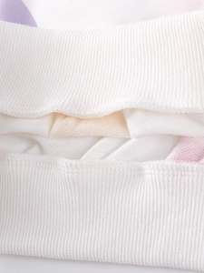 Close-up of girls sweatshirt ribbed cuffs and hem with colorful abstract prints