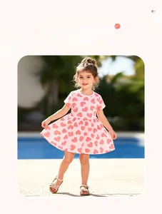 Short-sleeve pink cotton girl dress with red heart prints worn at a sunny poolside