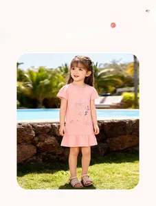 Close-up of girls' pink cotton summer dress with floral embroidery and bow detail
