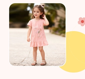 Close-up of pink cotton dress for girls featuring floral embroidery and bow details