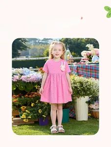 Outdoor shot of a pink girls' dress featuring a 3D bunny applique and pleated waist