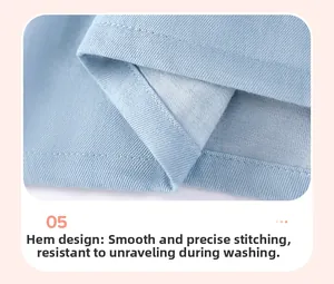 Detailed view of the denim dress hem featuring precise double-needle stitching and texture