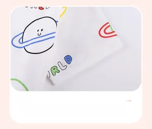Detail of soft cotton kids t-shirt cuff with colorful cartoon space planet print