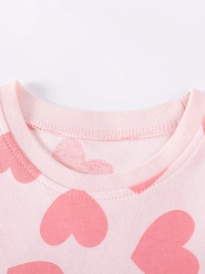 Pink crew neck cotton dress for girls featuring a large dark pink heart print pattern
