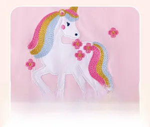 Detailed macro shot of premium unicorn embroidery on pink knit cotton girl outfit