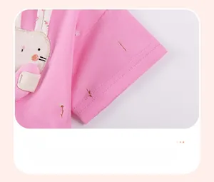 Detail of pink cotton dress sleeve with floral print and rabbit embroidery