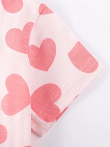 Pink short sleeve dress for girls featuring cute red heart patterns and soft cotton fabric