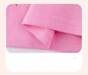 Detail of double-needle stitching on the hem of a pink cotton knit girls' dress