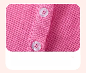 Macro detail of pink polo dress showing breathable cotton fabric and white buttons