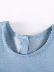 Girl's sleeveless light blue denim dress featuring a round neck and quality stitching