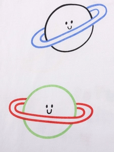 Close-up of cute cartoon planet prints on white cotton fabric for kids' summer T-shirt