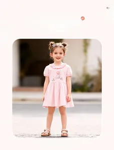 Close-up of pink cotton girl's dress with ruffled collar and mouse cartoon embroidery