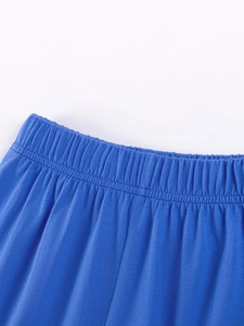 Macro detail of elastic waistband on boys blue cotton knit shorts with uniform stitching