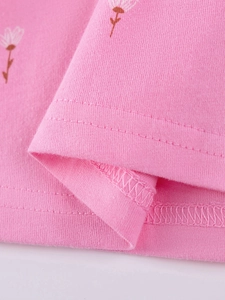 Pink cotton girls' dress featuring white floral print and high-quality hem stitching