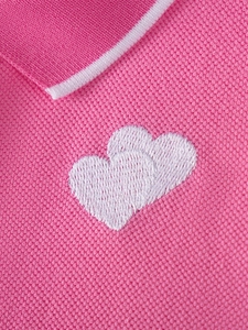 Pink cotton girls' polo dress with pique knit texture and white heart embroidery details