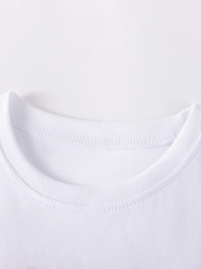 Close-up of a white knit mesh dress for girls with classic crew neck and fine texture