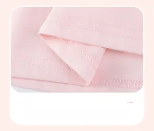 Detail of double-needle stitching and flat lock seams on a pink cotton girl's dress hem