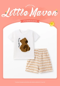 Détail d'un T-shirt en coton blanc avec écusson d'ours et short à carreaux