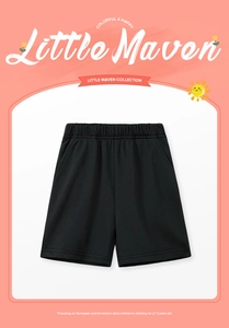 Detail of black cotton kids shorts featuring elastic waistband and functional side pockets