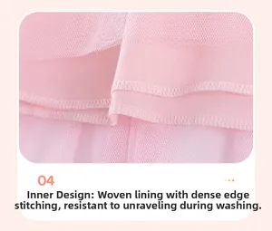 Detail of pink girls dress showing woven lining and mesh with neat stitching seams