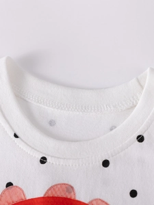 Polka dot white cotton dress for girls featuring a ribbed crew neck and cartoon details