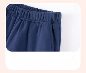 Detailed view of elastic waistband and side pocket on navy blue cotton boys' shorts