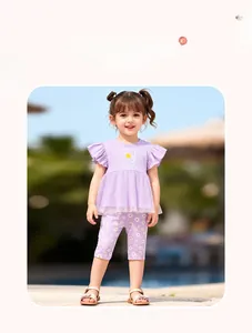 Detail of girl's summer outfit with daisy prints, ruffled sleeves and mesh hem