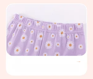 Detail of elastic waist on lilac girls' shorts with white daisy floral pattern