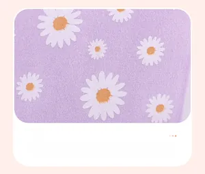 Detail of purple summer girls' clothing with white and orange daisy flower pattern