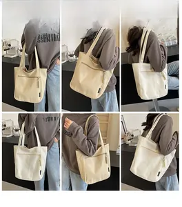 Close-up of canvas tote bag with front zipper pocket and stylish woven zipper pulls
