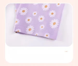Detail of baby girl purple knit shorts featuring a white daisy print and neat hem stitching